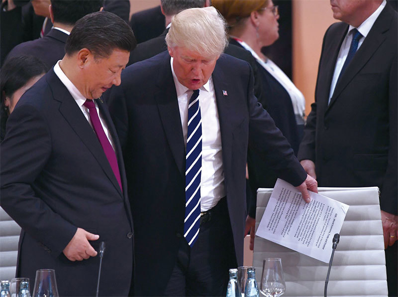 8月12日川普和習近平通話時，告知美國將在下周啟動301條款中國侵權調查。圖為7月7日德國漢堡G20峰會川習互動。（Getty Images）