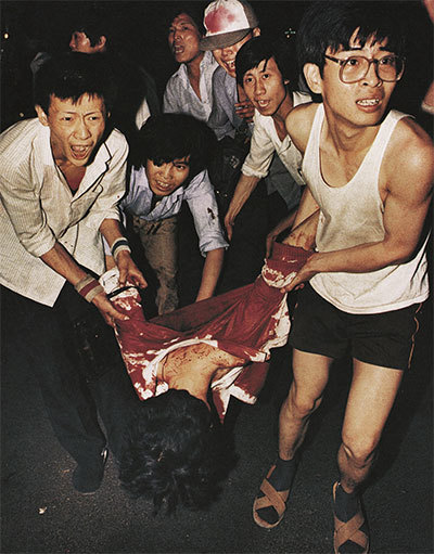 1989年6月4日凌晨，北京長安街，數名學生在搶救一名遭到中共軍隊開槍射殺的同學。（資料圖片）