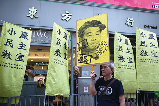 圖為2017年香港七一遊行，民眾要求查辦梁振英涉收受澳洲UGL公司400萬英鎊賄賂案。（AFP）