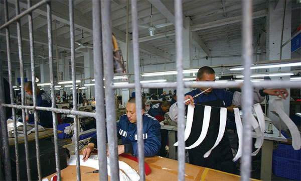2008年3月7日，囚犯在中國重慶市一家監獄的縫紉車間裡工作。（China Photos/Getty Images）