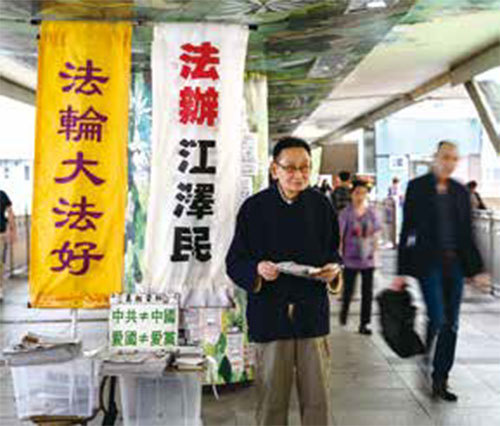 香港《大紀元時報》在尚未上架銷售之前，每周有五天會在街頭派發免費報紙。圖為一名年長法輪功學員2019年4月2日在香港街頭義務派發《大紀元時報》。（AFP）