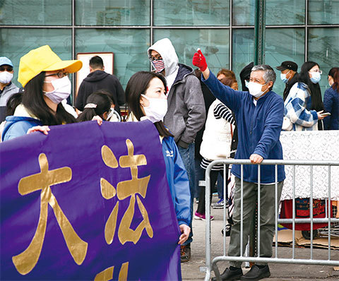 4月18日，紐約法拉盛民眾對法輪功遊行隊伍豎起大拇指。（Samira Bouaou/ The Epoch Times）