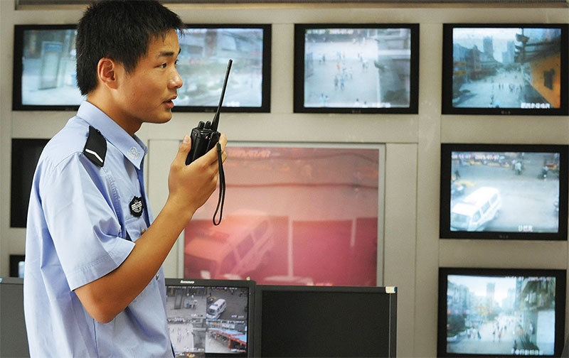 以「維穩」為藉口監控民眾是公安部最大的任務。圖為2009年7月12日，安徽省合肥近郊一名警察背後是路燈監控攝像機發回的鏡頭。（AFP）