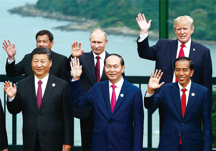 11月10日，川普（後排右一）到達越南出席APEC論壇時高調稱美國不會簽署束縛手腳的多邊貿易協議。外界普遍認為，川普的發言有暗指中共的意思。（AFP）