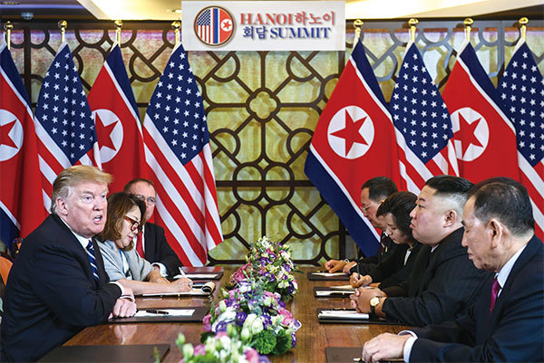 特朗普（左）與金正恩（右中）於2019年2月28日在越南河內舉行第二次美朝首腦會談，無果而終。（AFP）