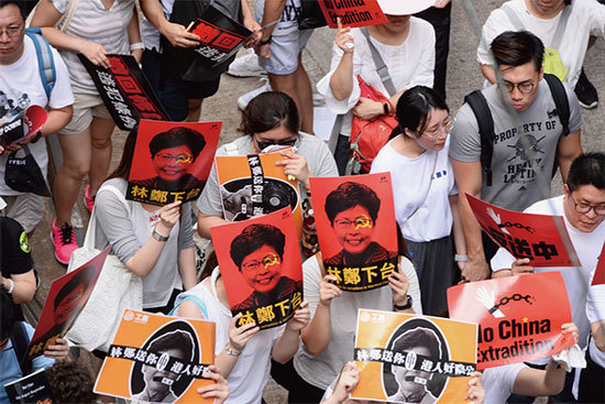 9日那天，總人口700萬人的香港，有100多萬市民都走出來參加遊行。許多抗議者穿著白色T恤，揮舞著反送中的紅色標誌，呼籲北京支持的特首林鄭月娥下臺。（宋碧龍／大紀元）